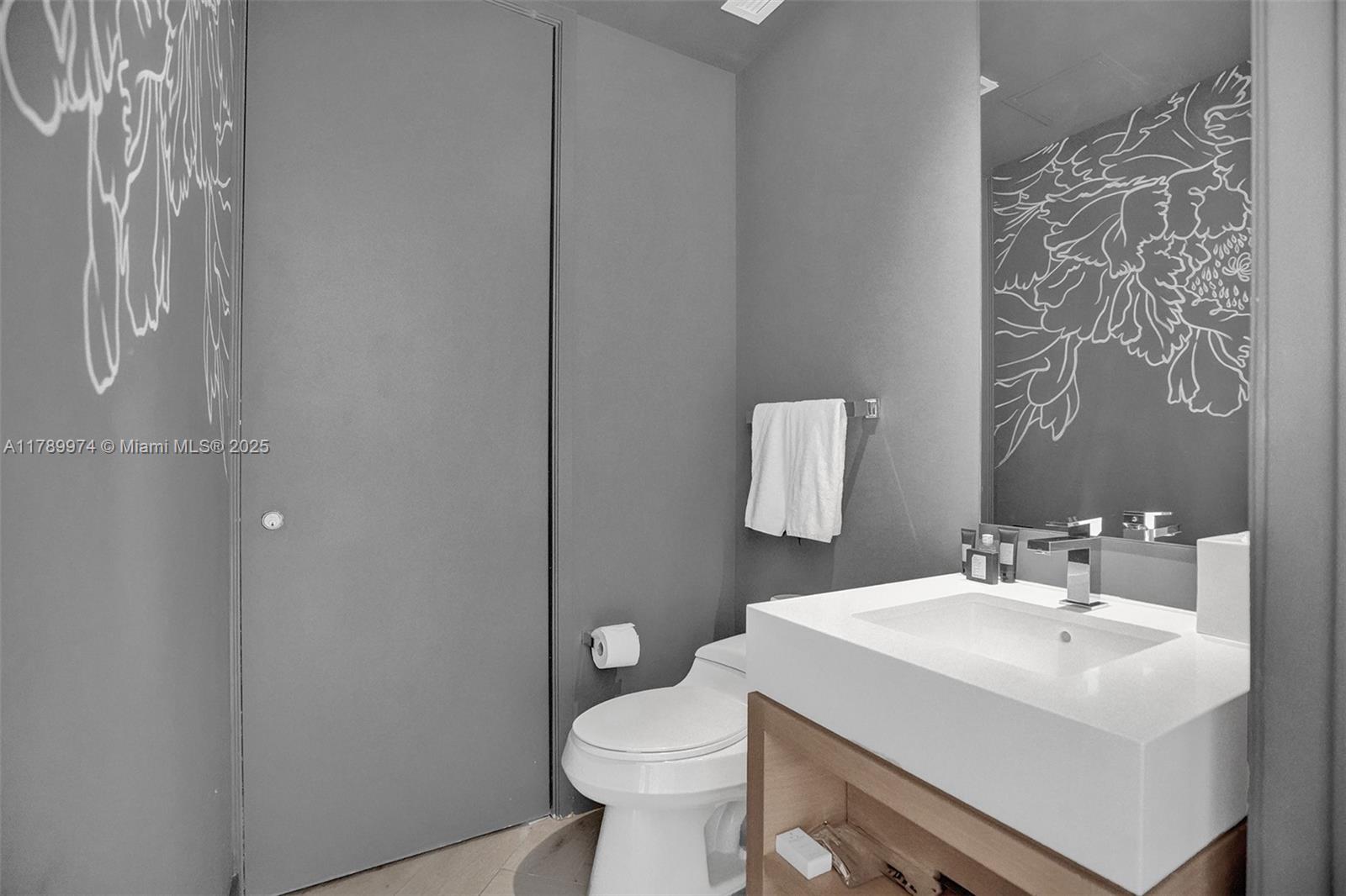 2201 Collins Avenue, Unit 1215 Miami Beach, FL 33139 - Photo 11 of 15 a bathroom with a sink toilet and a mirror