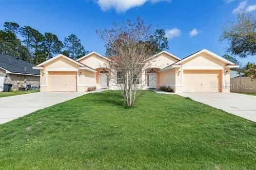 a front view of a house with a garden and yard
