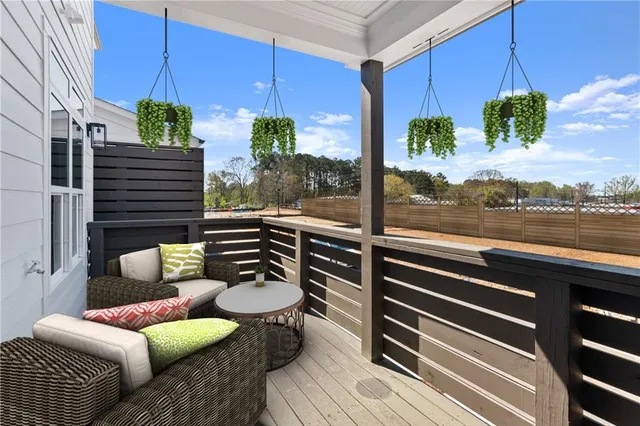 a view of a balcony with a floor to ceiling window with wooden floor