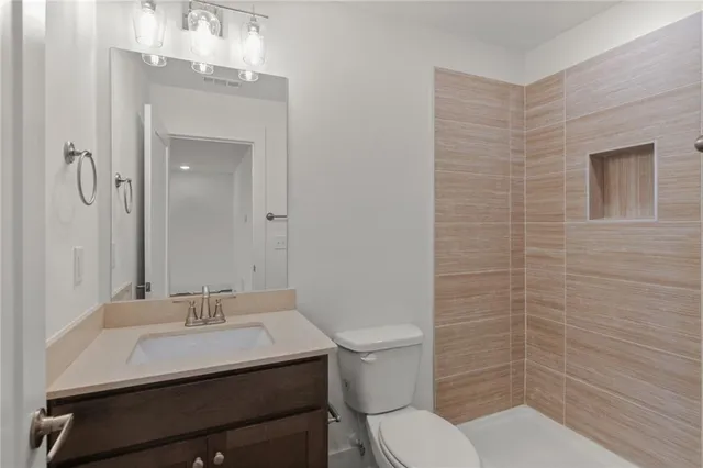 a bedroom with a bed and ceiling fan