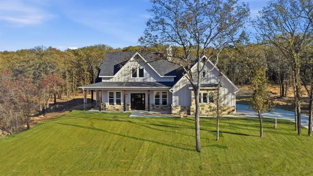 a view of a house with pool and sitting area