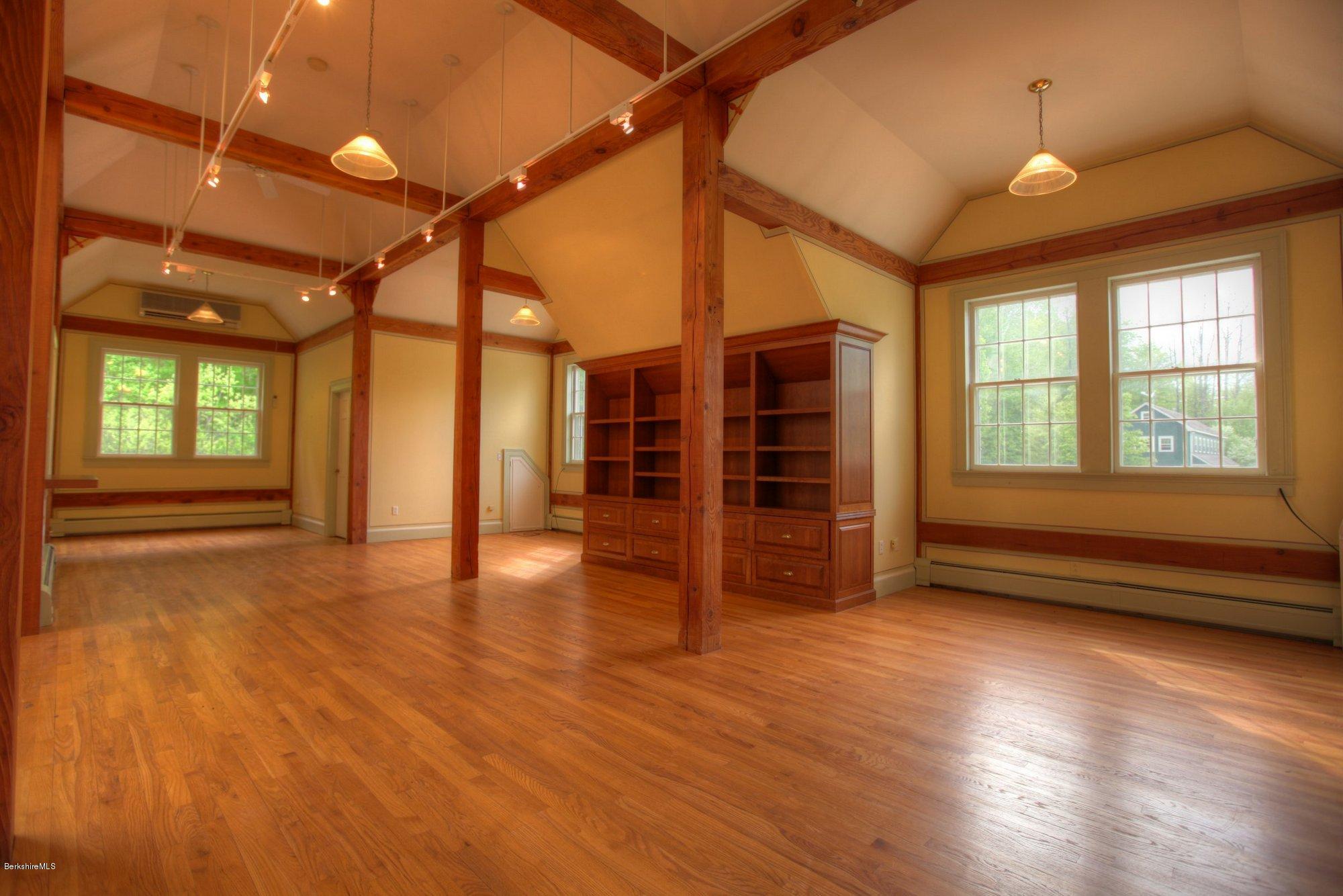 130 Jerusalem Road Tyringham, MA 01264 - Photo 7 of 15 a view of empty room with wooden floor and fan