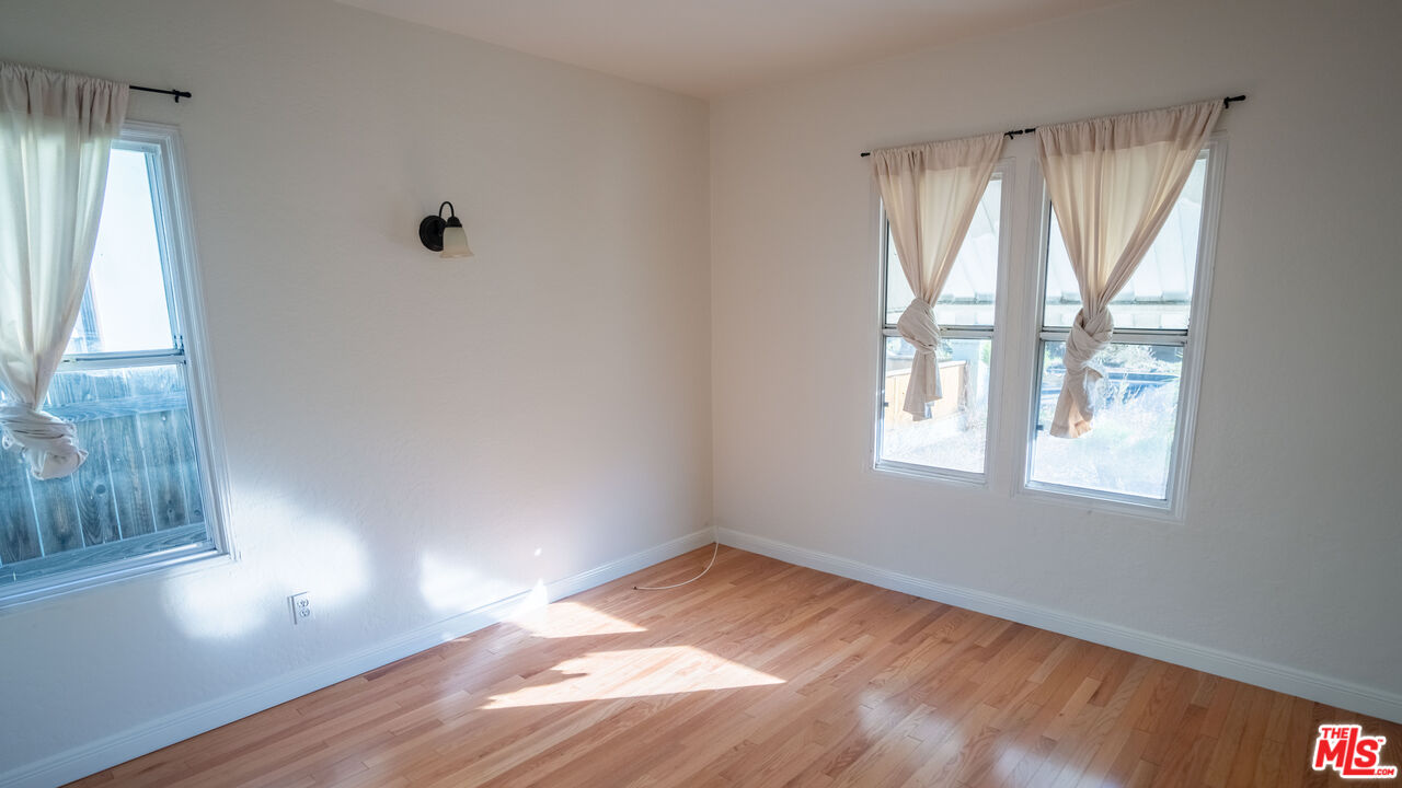 3411 Larga Avenue Los Angeles, CA 90039 - Photo 12 of 26 an empty room with wooden floor and windows