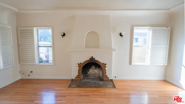a view of a livingroom with wooden floor and a window