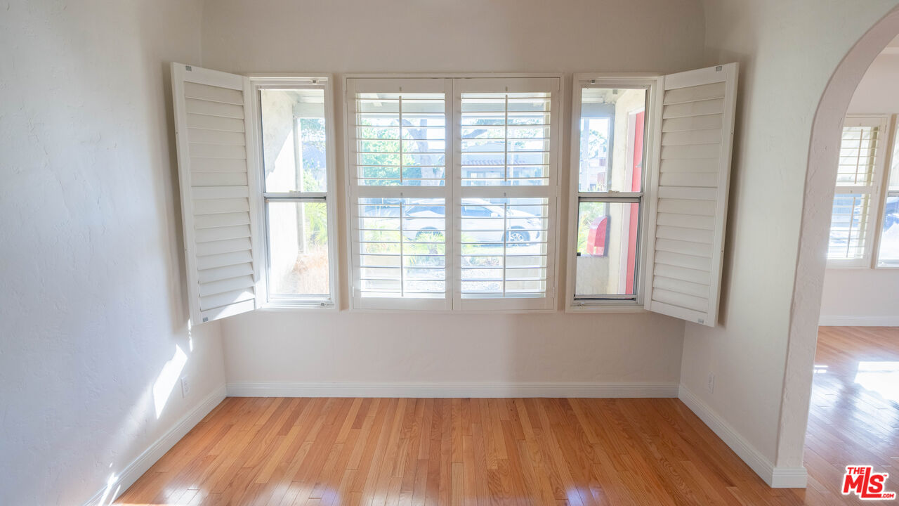 3411 Larga Avenue Los Angeles, CA 90039 - Photo 7 of 26 a view of an empty room with a window and wooden floor