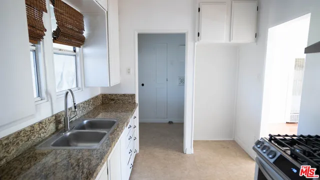 a kitchen with sink a stove and refrigerator