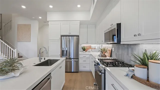 a kitchen that has a sink and a stove