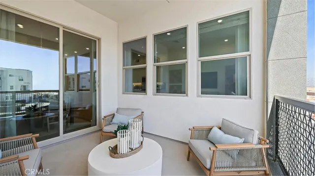 a living room with furniture and a floor to ceiling window