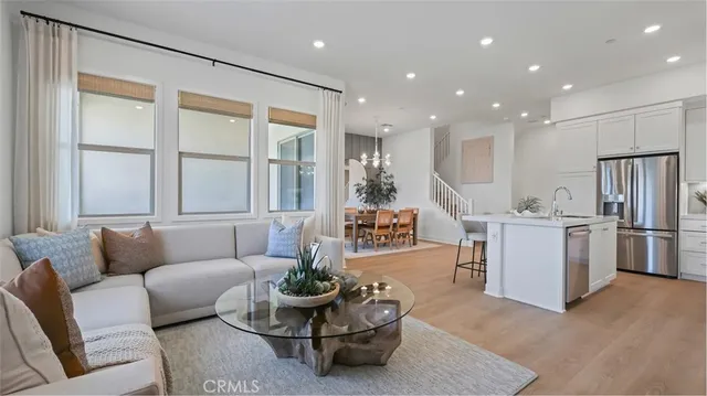 a living room with furniture and kitchen view