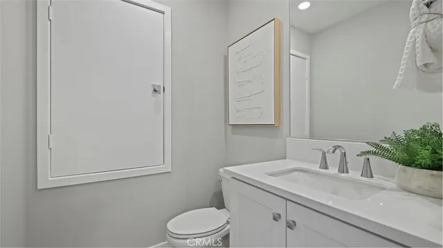 a bathroom with a sink a toilet and mirror