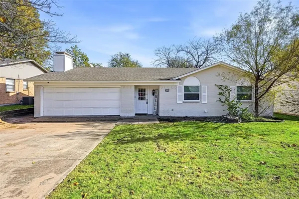 a view of backyard of house with green space