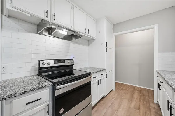 a kitchen with stainless steel appliances granite countertop a stove and a sink