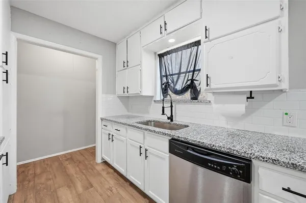 a kitchen with a sink stove and cabinets