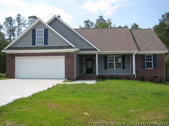 22 Rockingham Street Spring Lake, NC 28390 - Photo 1 of 20 a front view of a house with a yard and garage