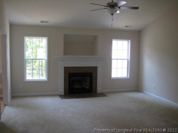 22 Rockingham Street Spring Lake, NC 28390 - Photo 12 of 20 an empty room with a fireplace and windows