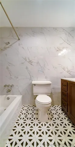 a bathroom with a toilet a sink and a shower