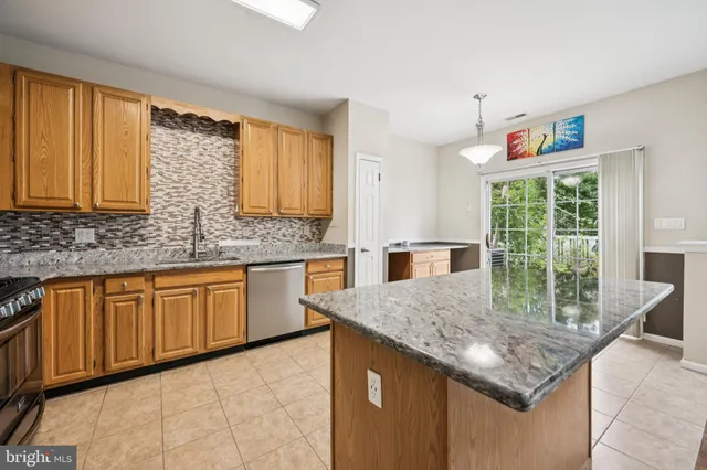 a kitchen with granite countertop a stove a sink and a granite counter tops