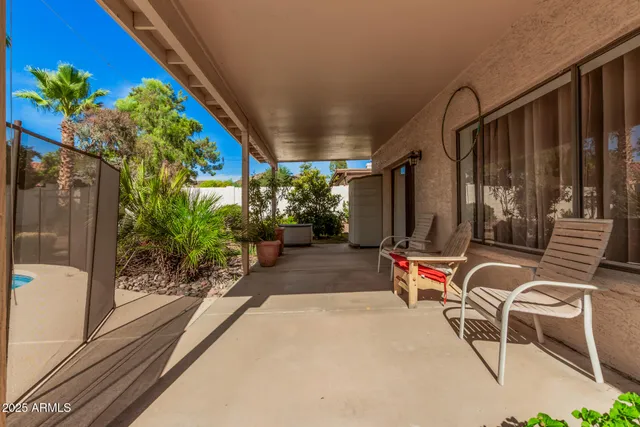 a view of a chairs and table in the balcony