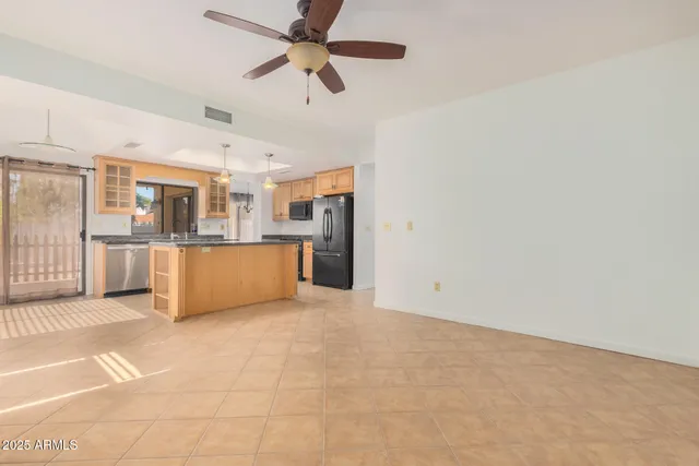 a view of a kitchen with a sink and a refrigerator