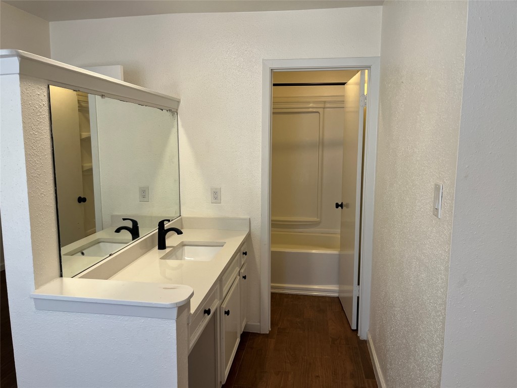 12119 Robin Ridge Lane Austin, TX 78750 - Photo 7 of 9 a bathroom with a sink a mirror and a bathtub