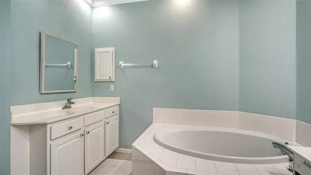 a bedroom with a bed and a mirror on dresser