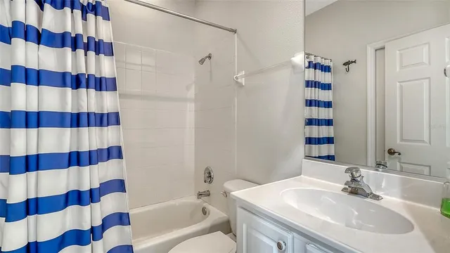 a view of a livingroom with furniture wooden floor and windows