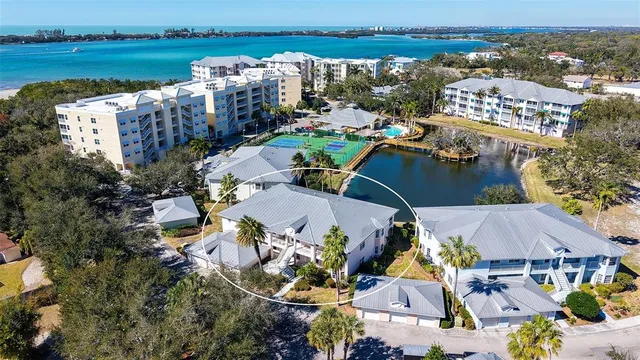 an aerial view of a house with outdoor space and lake view