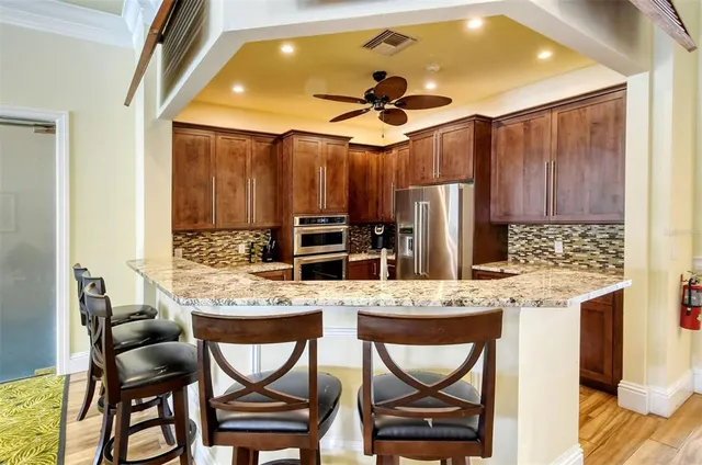 a view of a swimming pool with a lounge chair and palm trees