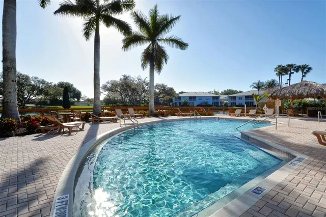 a view of swimming pool with outdoor seating and yard