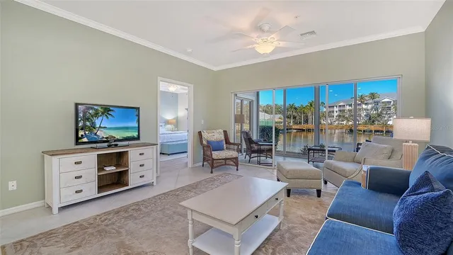 a living room with furniture and a floor to ceiling window