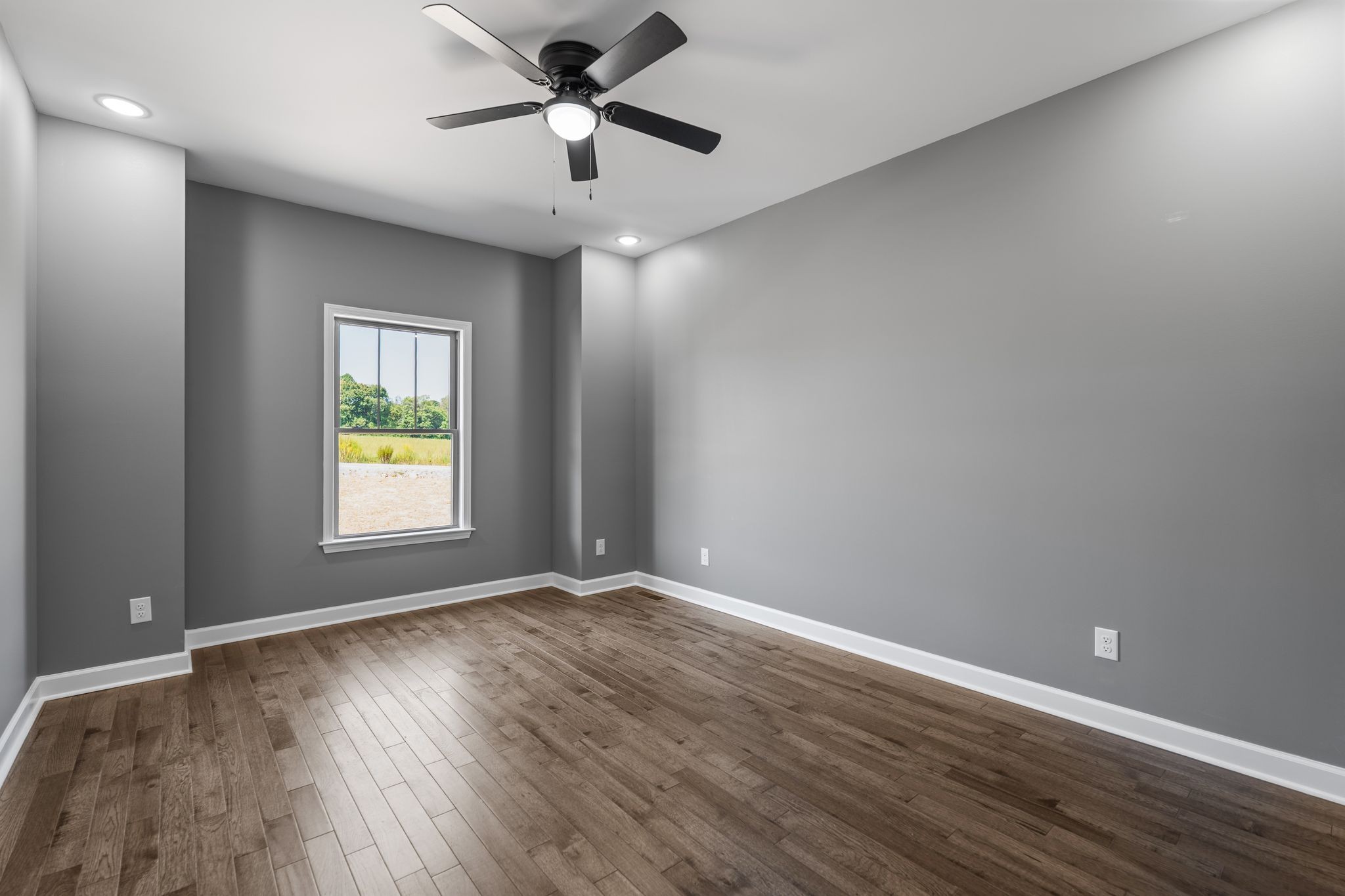 83 Watson Court Leoma, TN 38468 - Photo 12 of 18 an empty room with wooden floor and windows