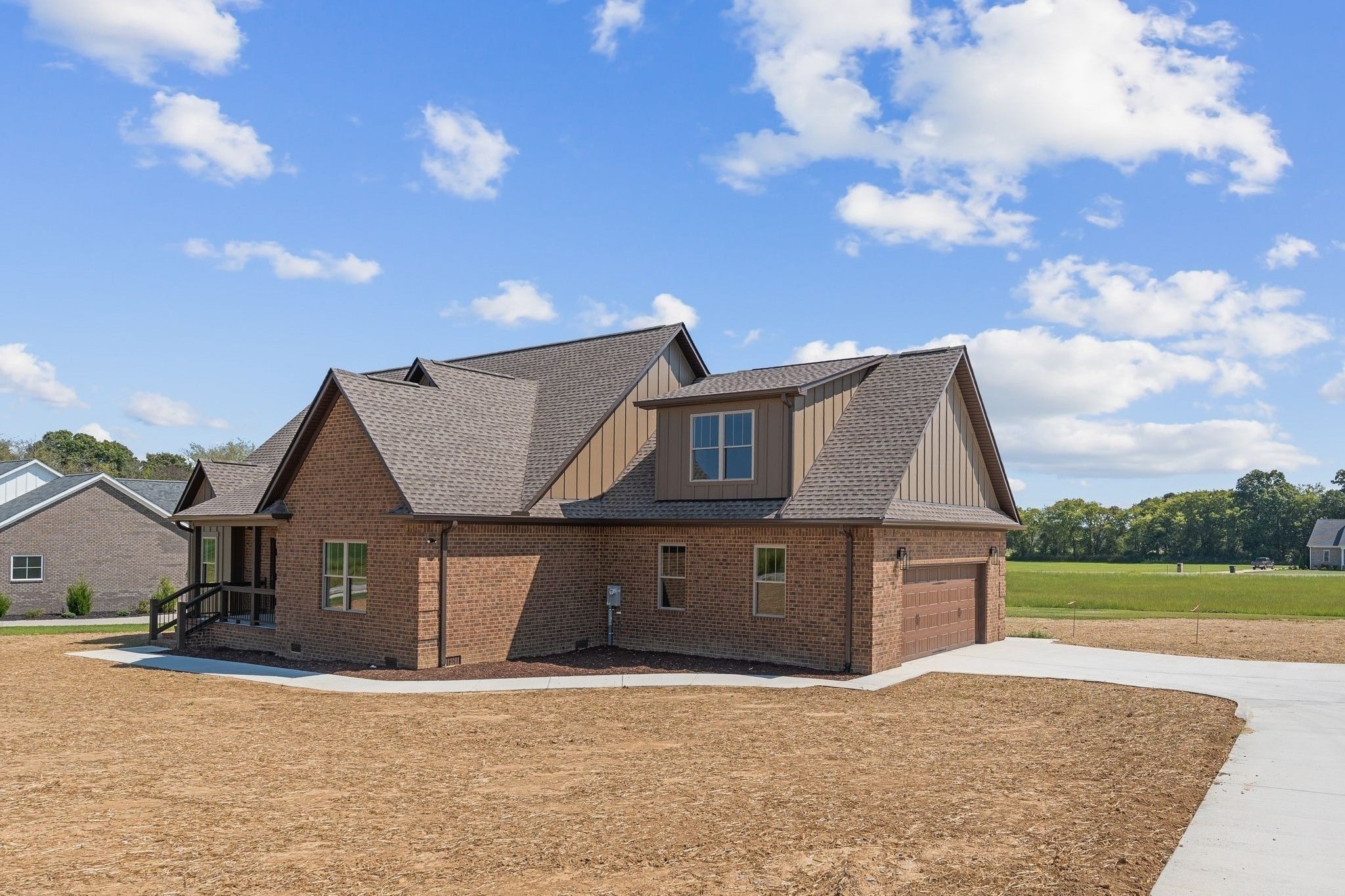 83 Watson Court Leoma, TN 38468 - Photo 2 of 18 a front view of a house with a garden and yard
