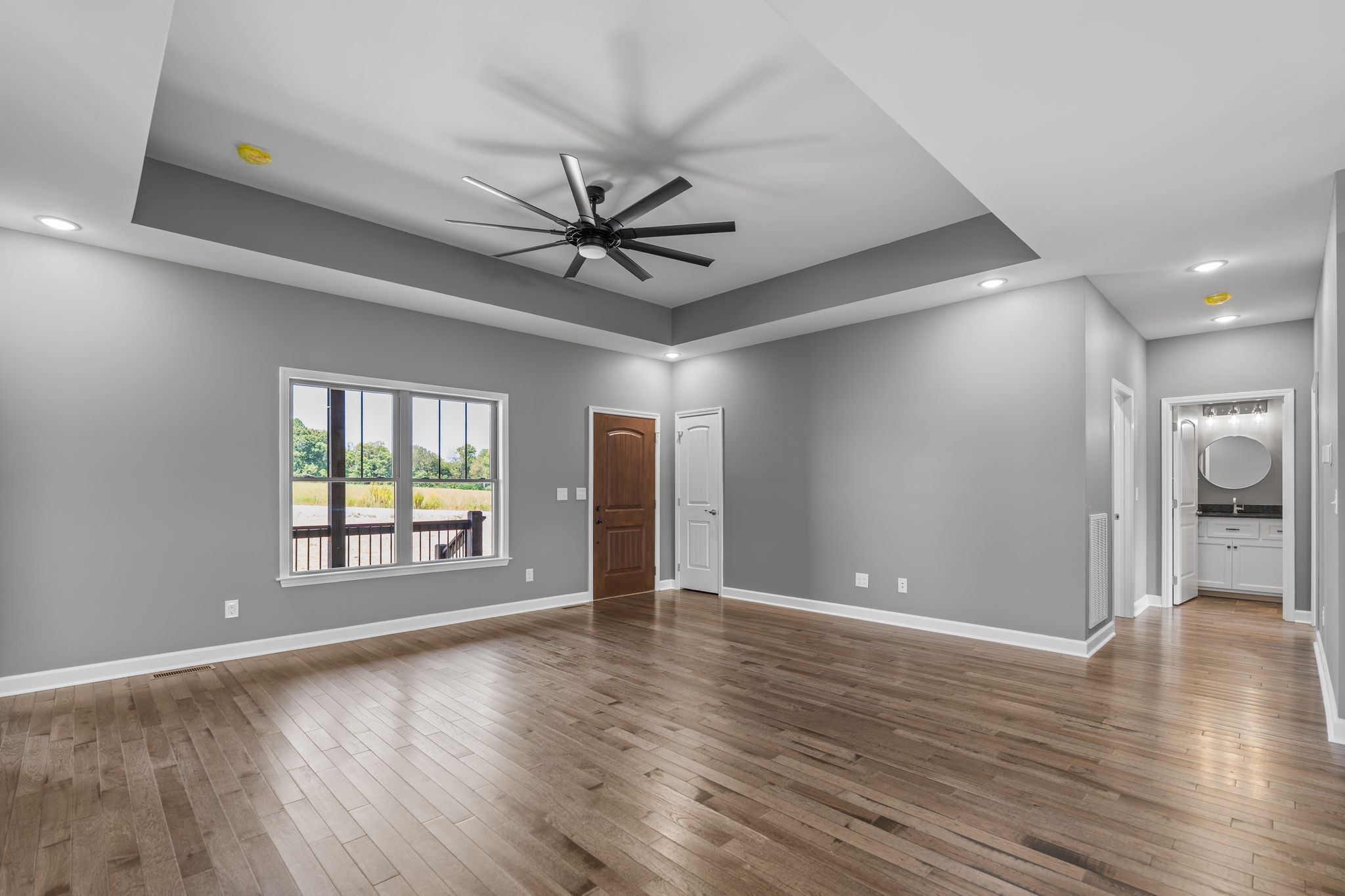 83 Watson Court Leoma, TN 38468 - Photo 4 of 18 a view of an empty room with window and wooden floor