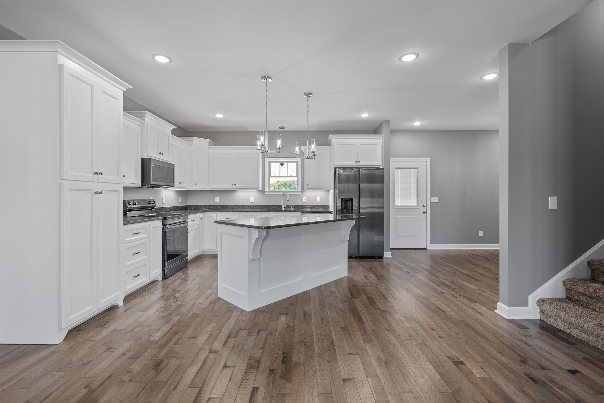 83 Watson Court Leoma, TN 38468 - Photo 7 of 18 a large kitchen with stainless steel appliances kitchen island a large counter top and a stove top oven