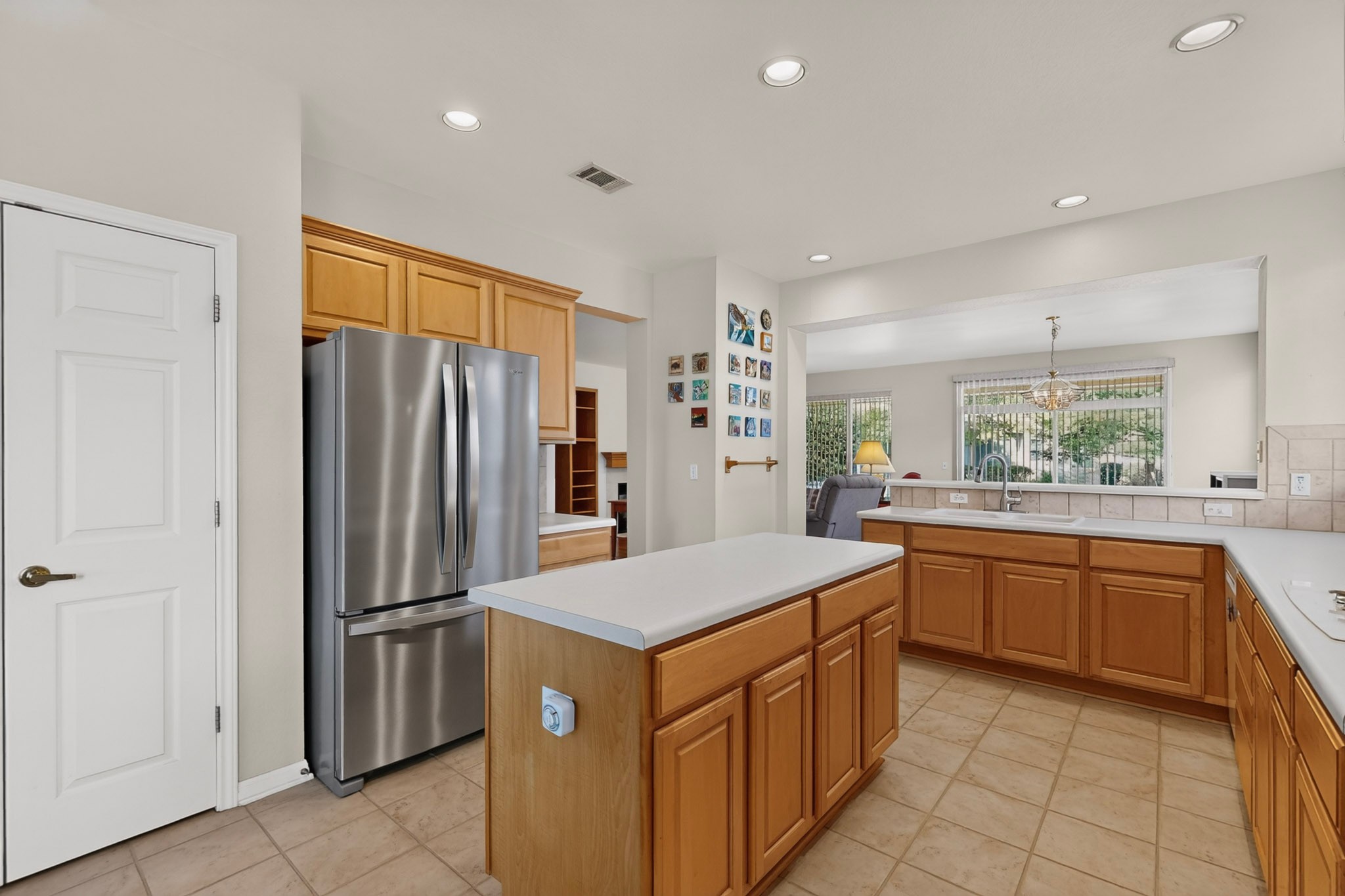 207 Red Poppy Trail Georgetown, TX 78633 - Photo 10 of 31 A well-appointed kitchen features a central island, stainless steel refrigerator, and ample cabinetry for organized living.