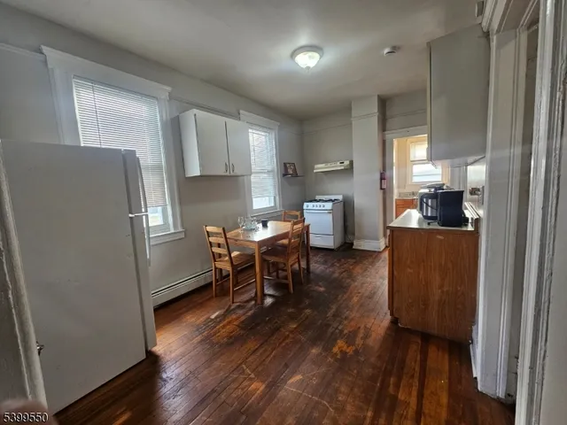 a kitchen with a refrigerator and a stove top oven