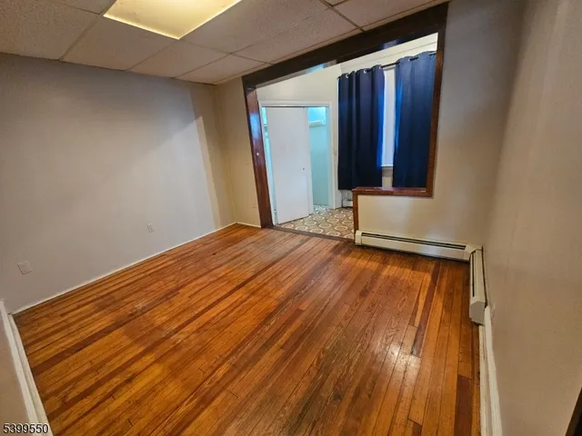 a view of a room with wooden floor