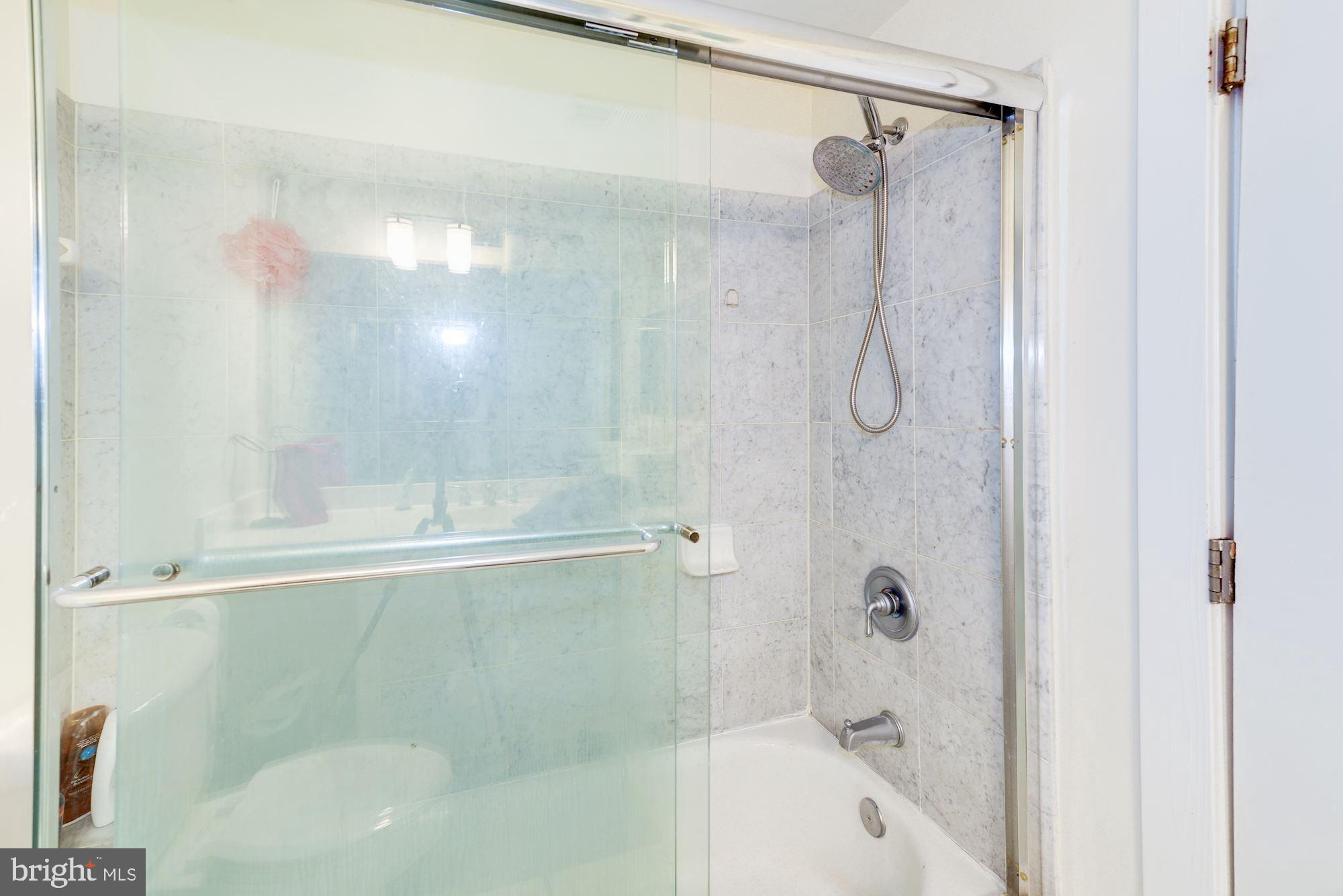 2363 Champlain Street Northwest, Unit 8 Washington, DC 20009 - Photo 22 of 30 a bathroom with a shower and a bath tub