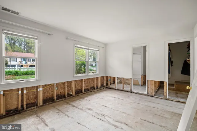 a bathroom with a toilet a sink and a window