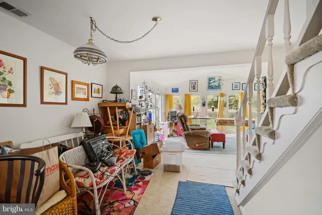 a kitchen with kitchen island granite countertop a sink appliances cabinets and a large window