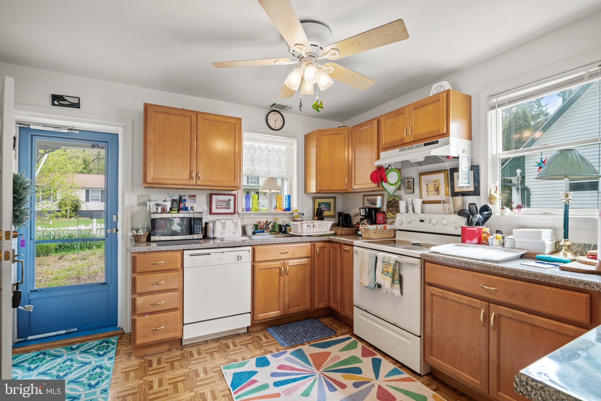 5930 Sneed Drive Deale, MD 20751 - Photo 25 of 38 a kitchen with kitchen island granite countertop a sink appliances cabinets and a large window