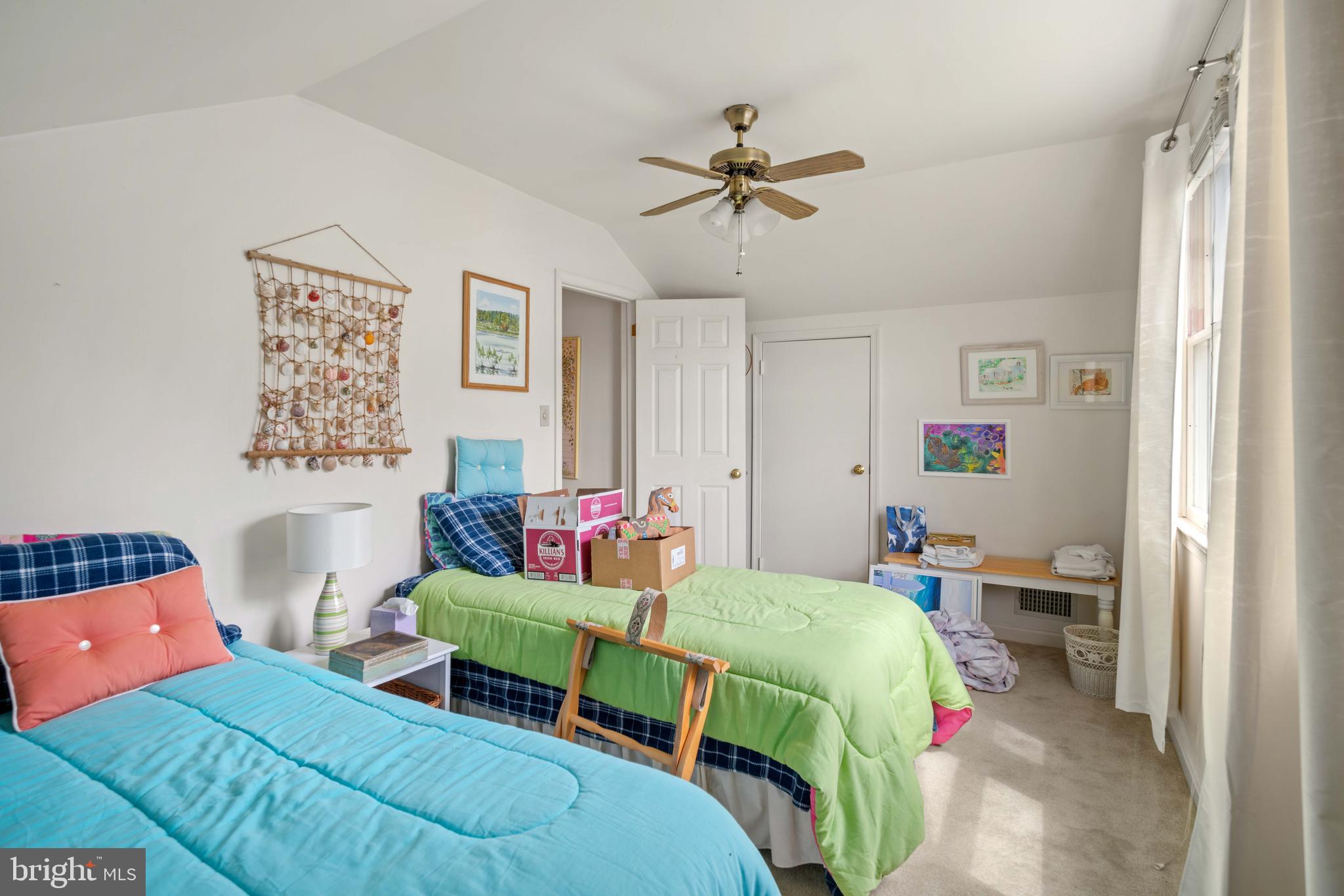 5930 Sneed Drive Deale, MD 20751 - Photo 31 of 38 a bedroom with a bed and a chandelier