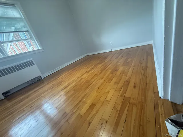 a view of an empty room and wooden floor