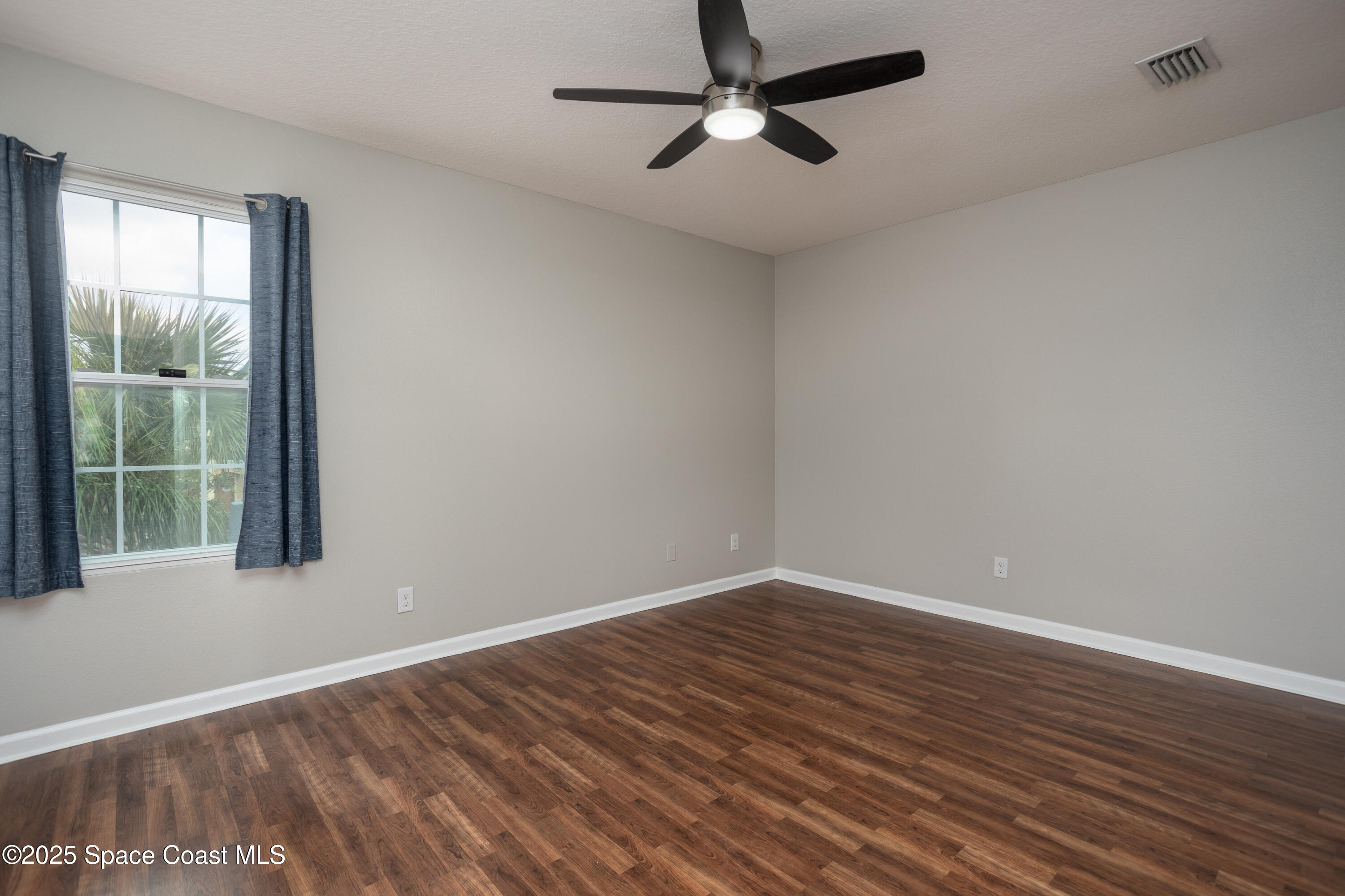 2780 Reston Street, Unit 104 Melbourne, FL 32935 - Photo 14 of 29 wooden floor in an empty room with a window