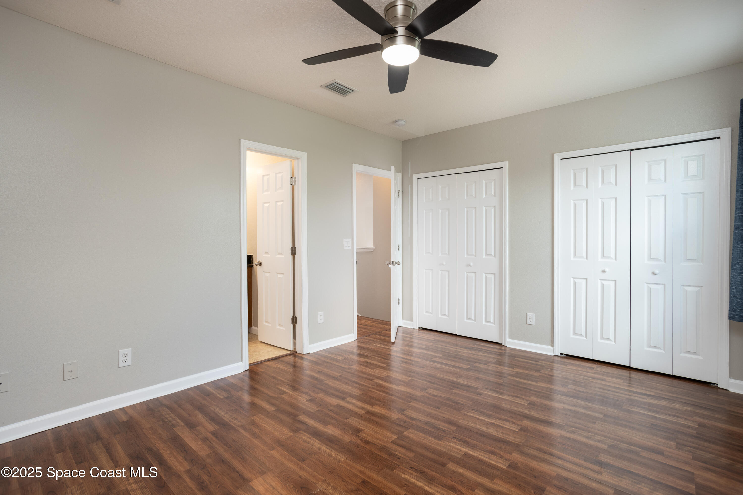 2780 Reston Street, Unit 104 Melbourne, FL 32935 - Photo 16 of 29 an empty room with wooden floor and windows