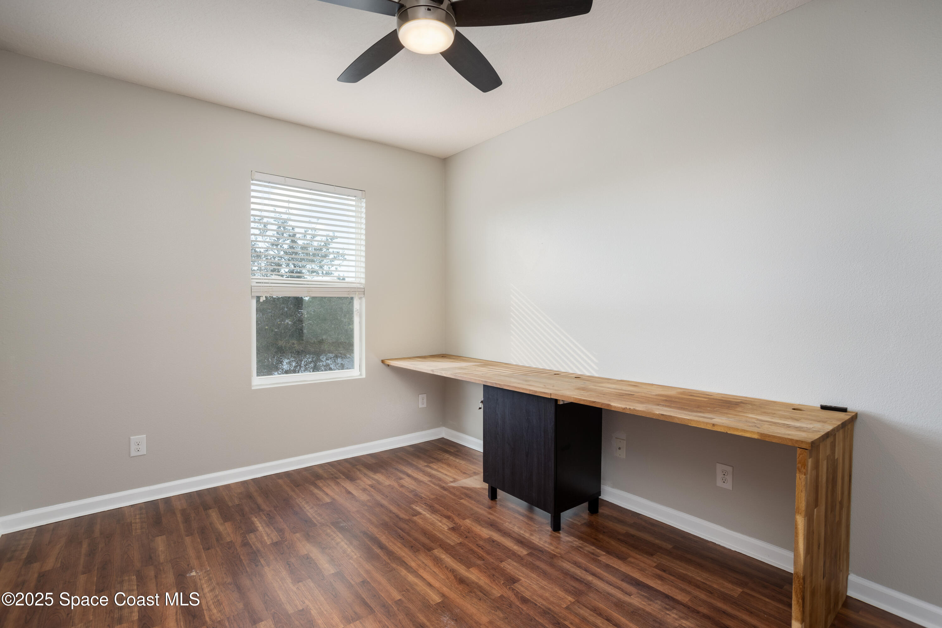 2780 Reston Street, Unit 104 Melbourne, FL 32935 - Photo 19 of 29 a view of room with window and wooden floor