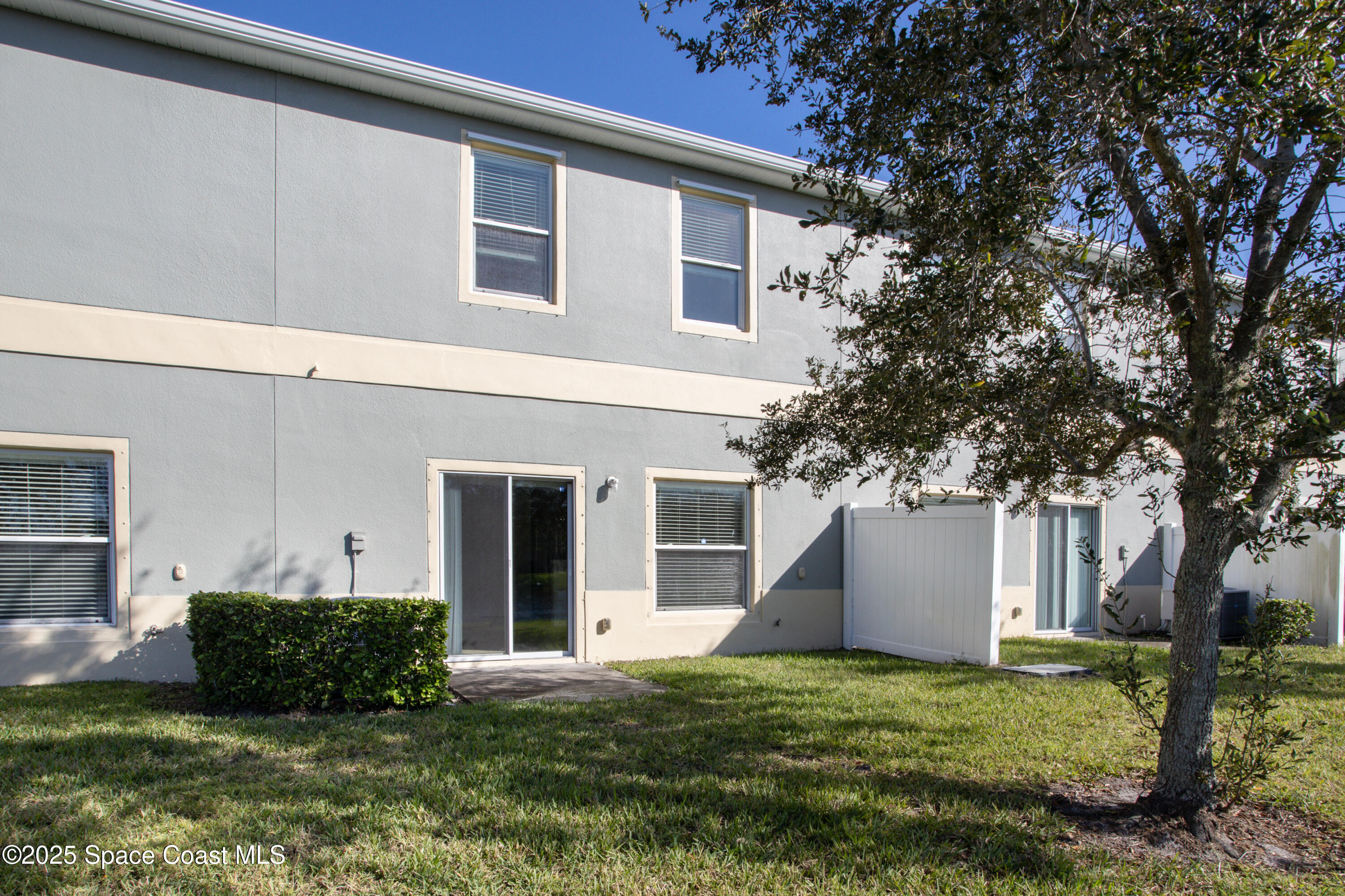 2780 Reston Street, Unit 104 Melbourne, FL 32935 - Photo 21 of 29 a view of a house with backyard and a tree