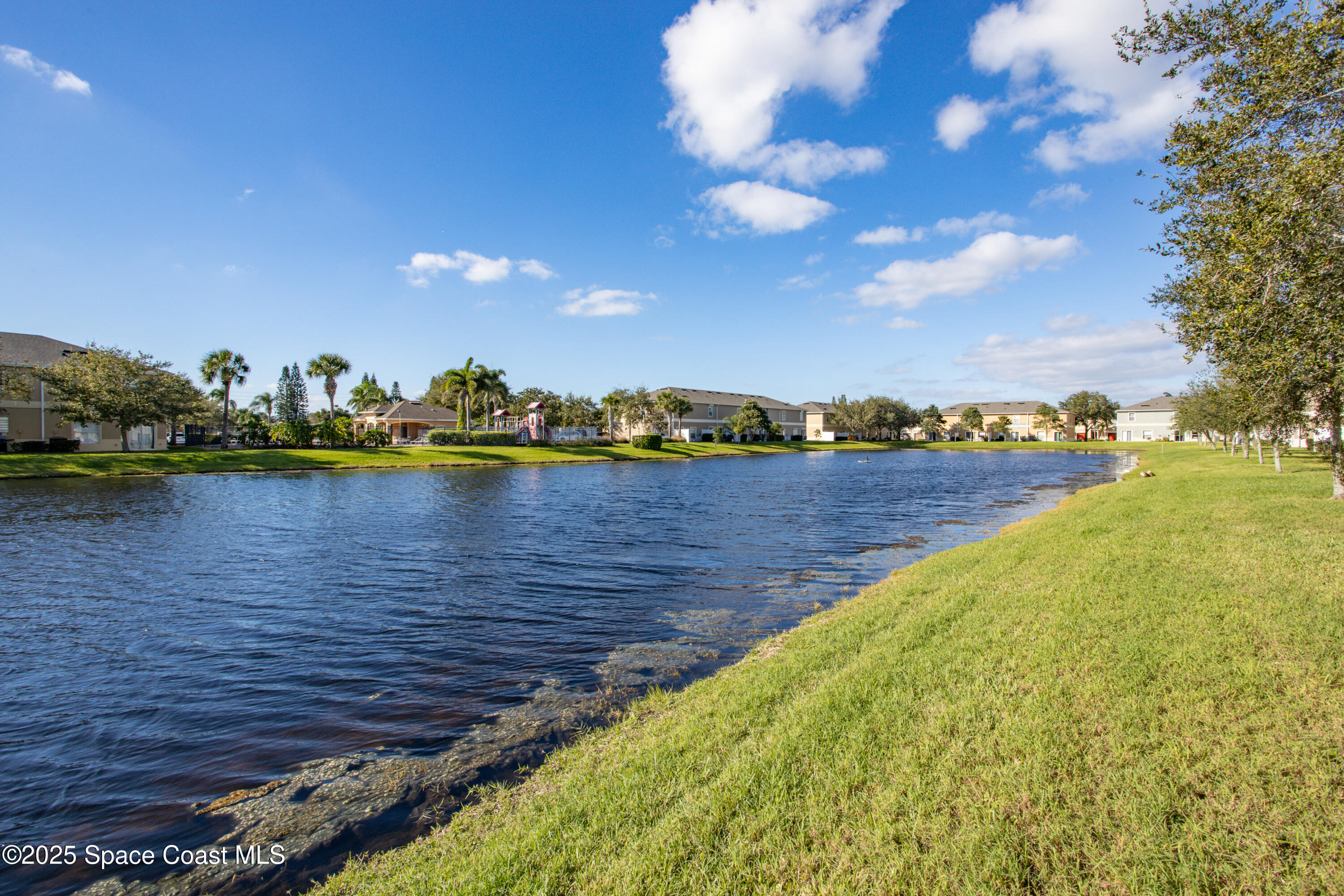 2780 Reston Street, Unit 104 Melbourne, FL 32935 - Photo 23 of 29 a view of a lake with houses in the back