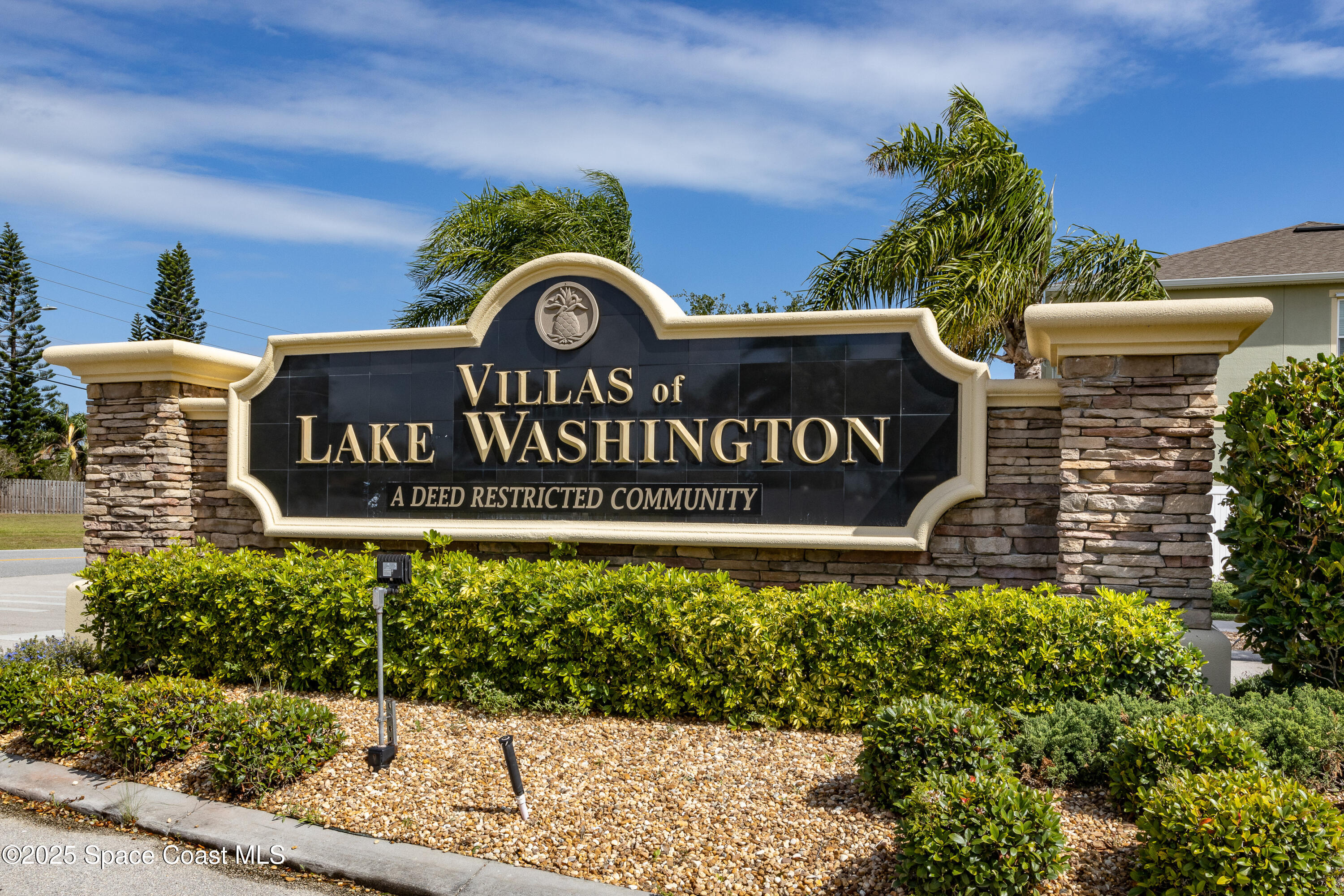 2780 Reston Street, Unit 104 Melbourne, FL 32935 - Photo 24 of 29 a view of outdoor space with signage and flags