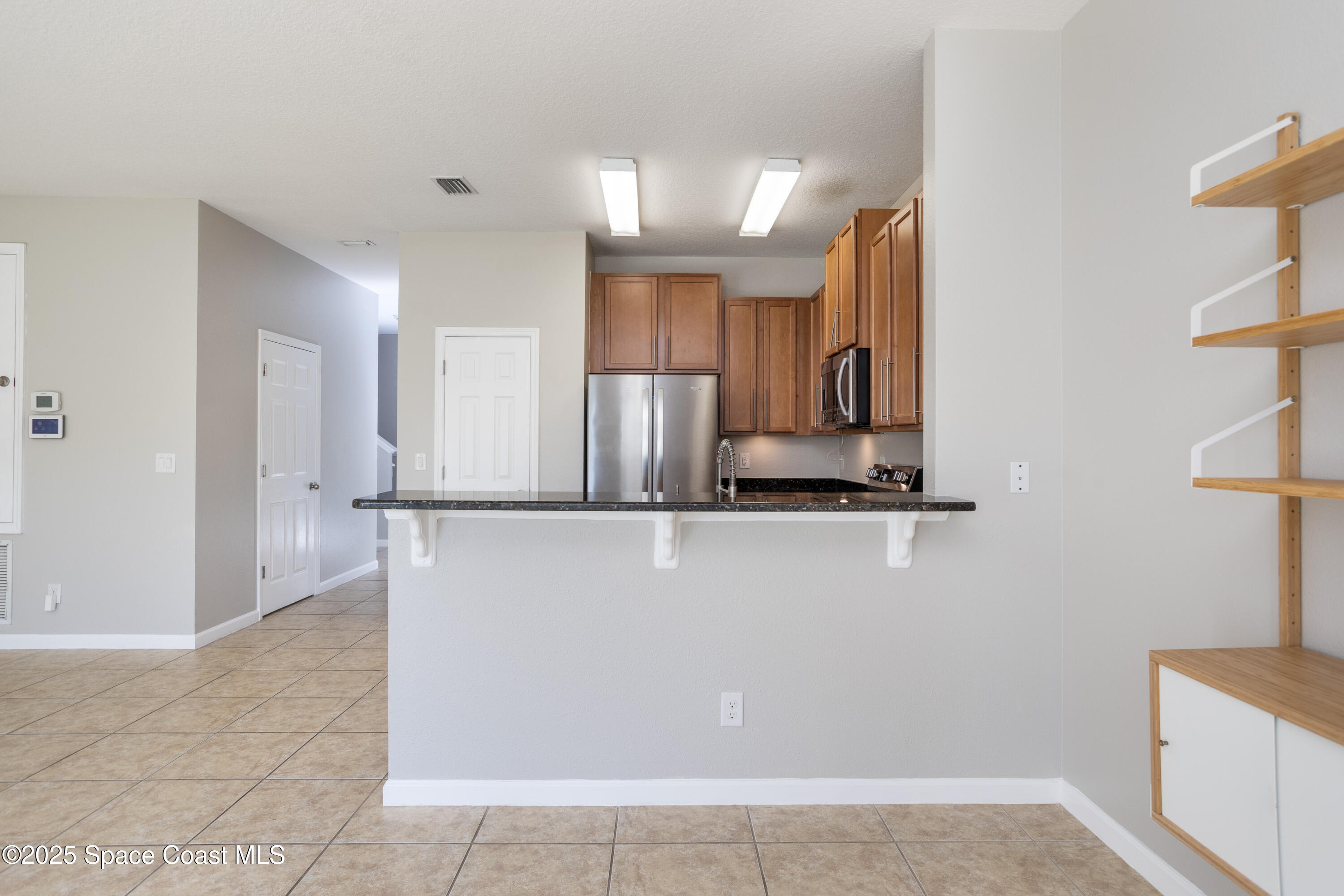 2780 Reston Street, Unit 104 Melbourne, FL 32935 - Photo 5 of 29 a view of kitchen with stainless steel appliances granite countertop a refrigerator and a sink